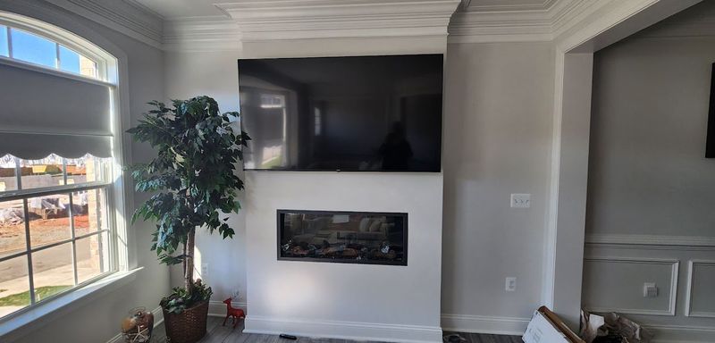 TV mounted above fireplace